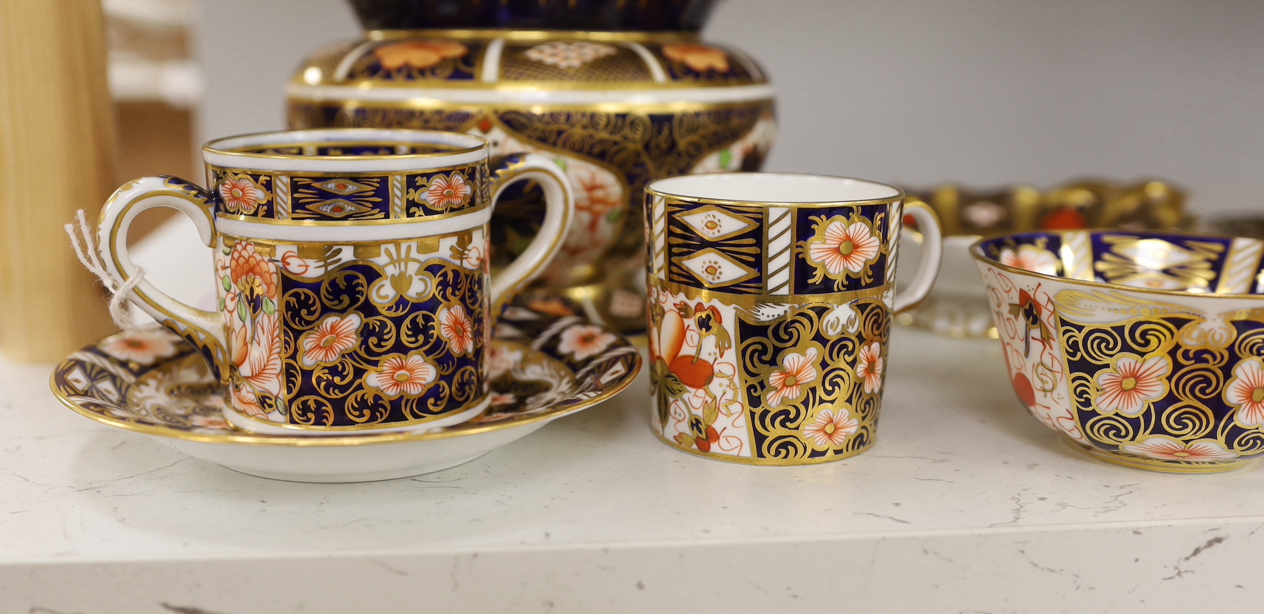A Royal Crown Derby spherical vase with pie crust rim painted with pattern 1128, a two handled dish in the same pattern, five cups and three saucers in pattern 2451